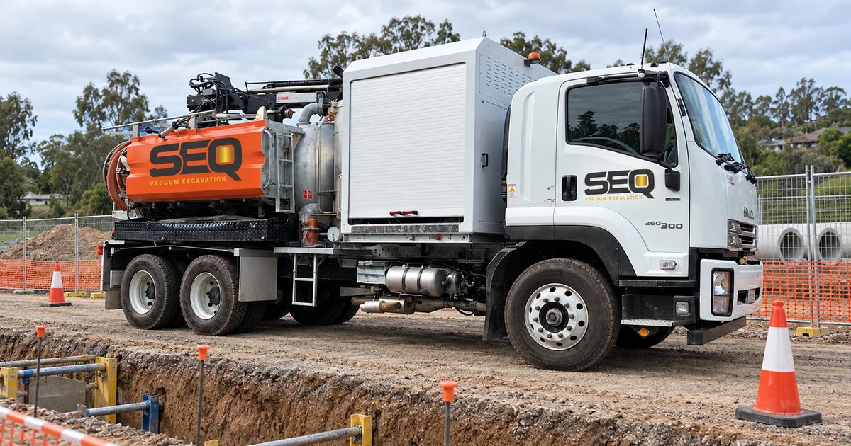 Vacuum excavation truck beside exposed underground services